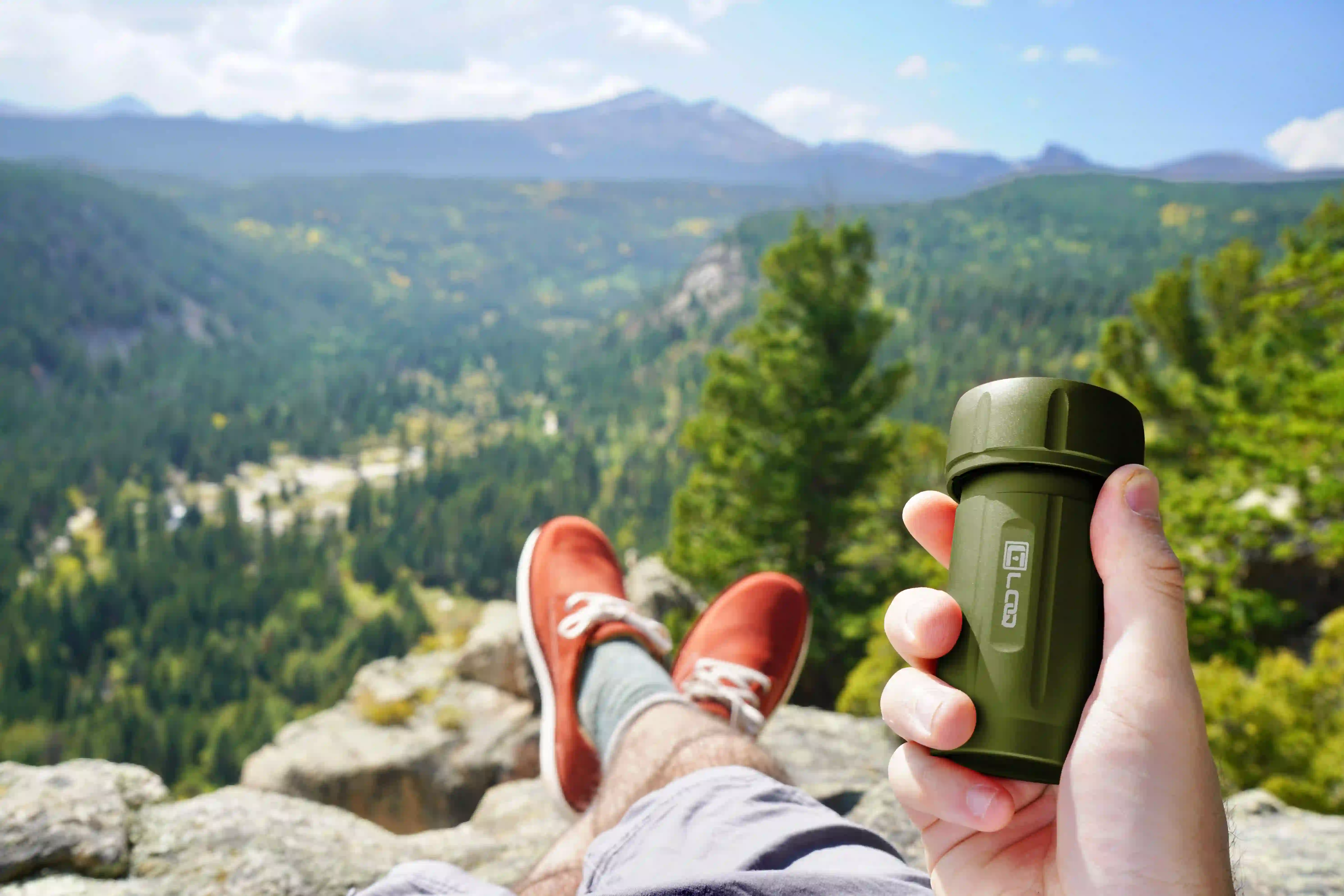 mountain-adventure-with-green-corloq an outdoor mountain scene showing a climber with a green corloq container